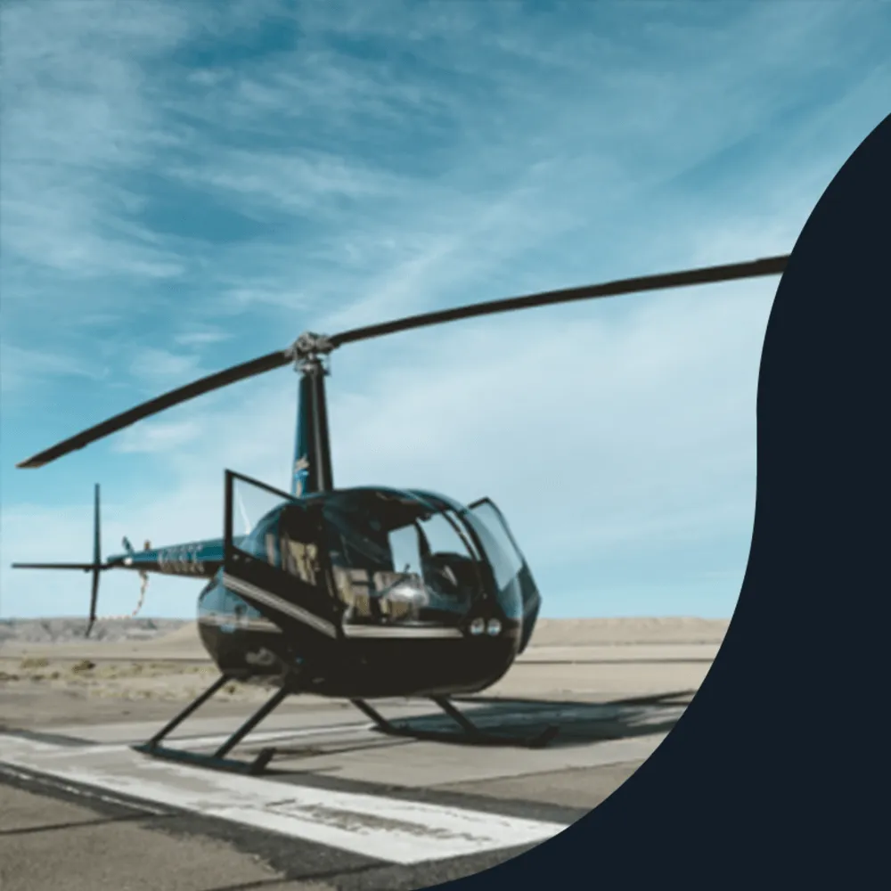 Black helicopter parked on an airfield helipad