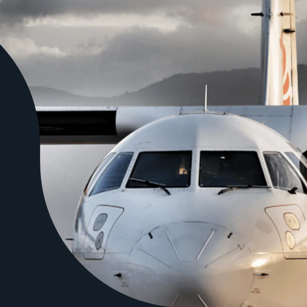 Nose and cockpit windows of a white turboprop aircraft