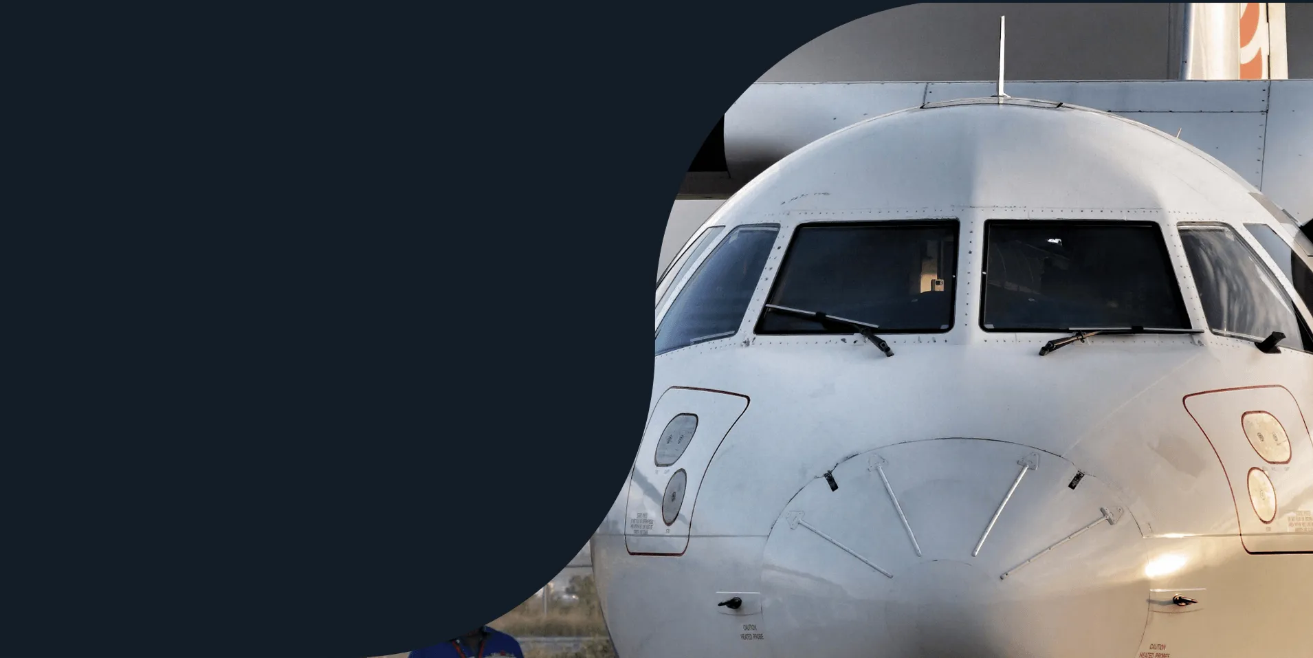 Nose and cockpit windows of a white turboprop aircraft